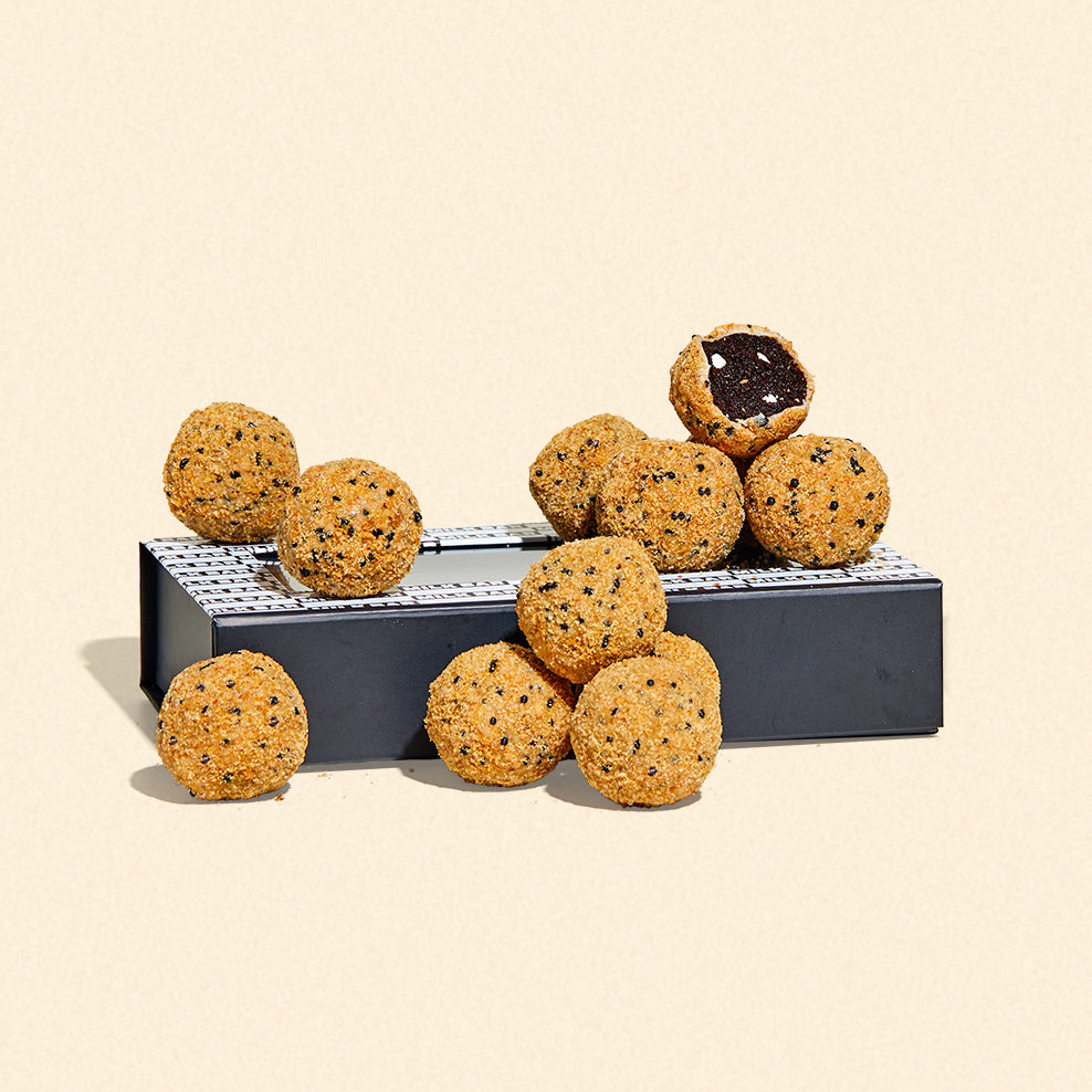 a s'mores truffle dozen gift box with 12 s'mores truffles sitting on top.