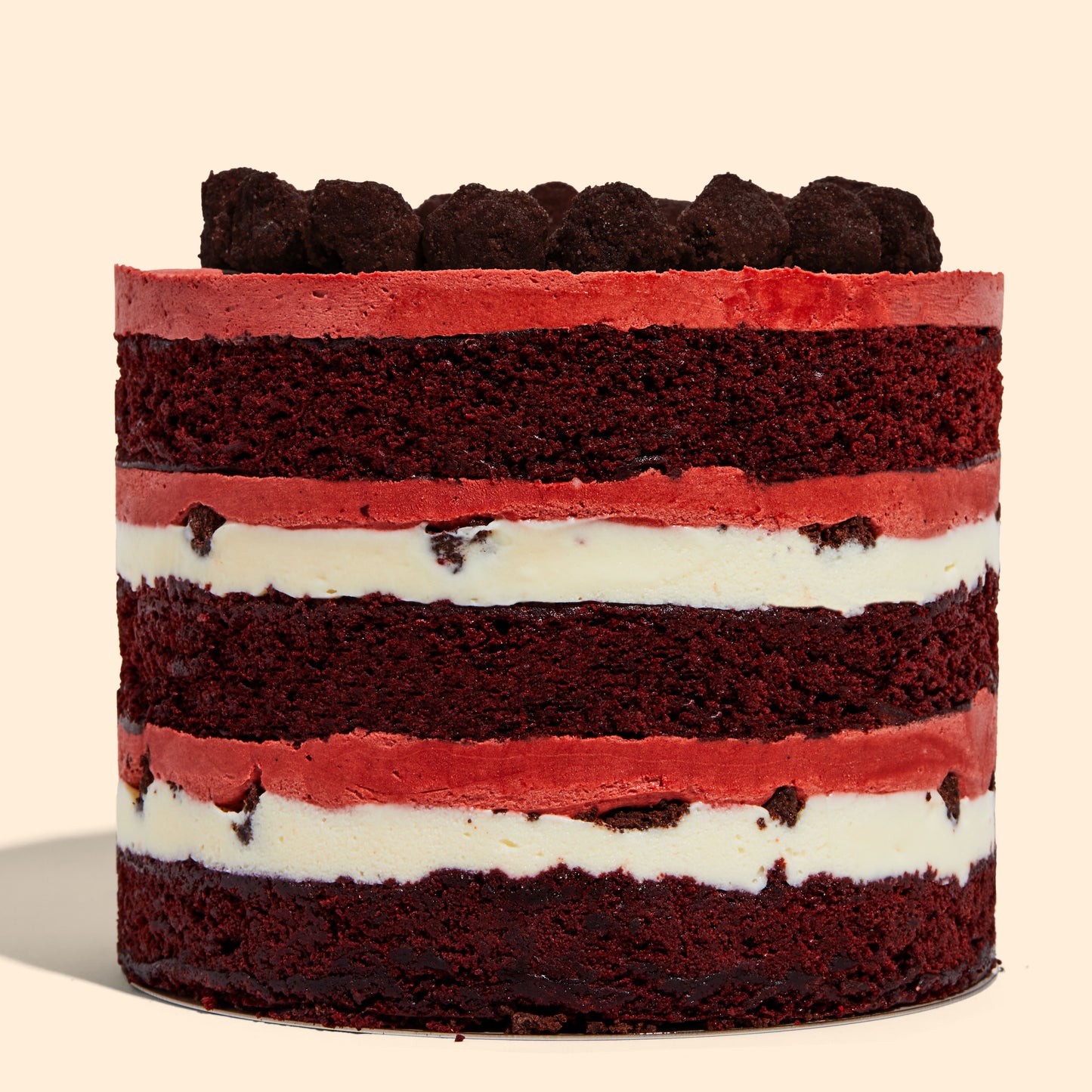 Side shot of the 6" Red Velvet Cheesecake Cake, displaying all the frostings and fillings up close.