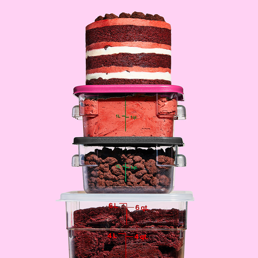 3 containers stacked on top of each other containing the frosting and fillings in the red velvet cake layers, with a whole cake sitting on top