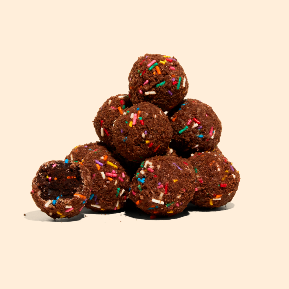 A pile of chocolate birthday cake truffles.