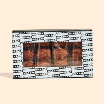 A front view of the chocolate birthday cake truffle dozen box with individually wrapped truffle 3-packs inside.