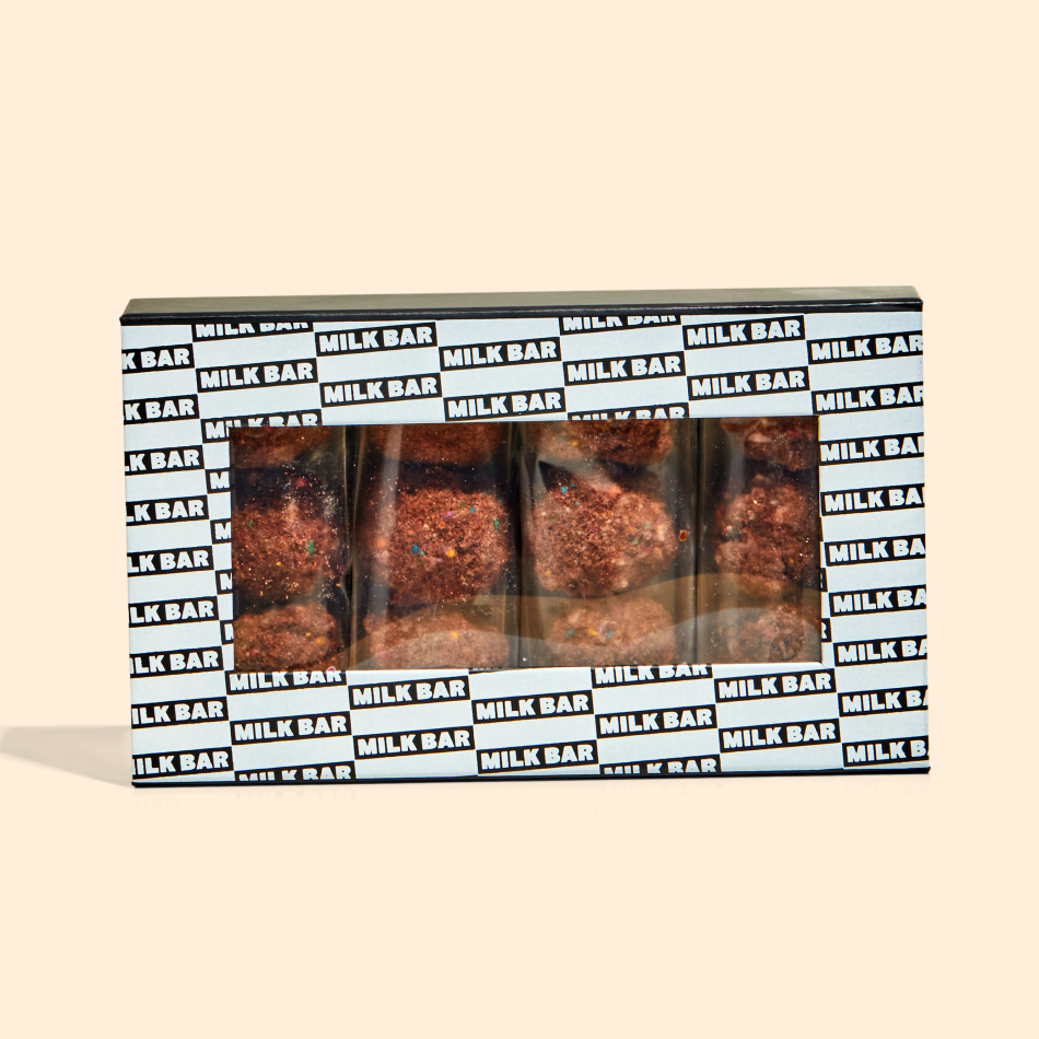 A front view of the chocolate birthday cake truffle dozen box with individually wrapped truffle 3-packs inside.