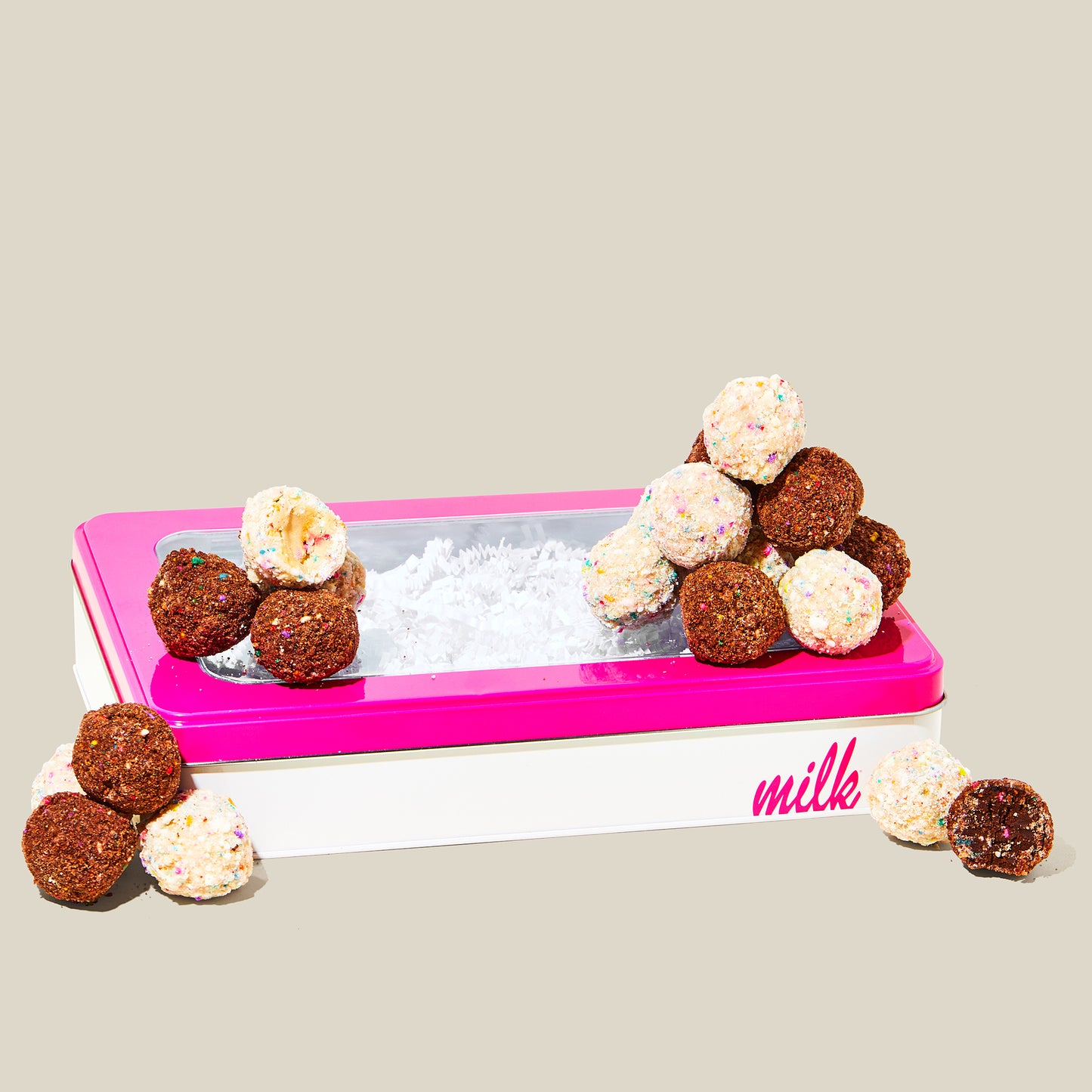 Chocolate B'day Truffles and Birthday Cake Truffles sitting on top of Milk Bar branded tin.